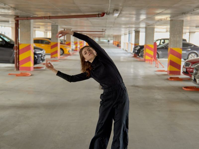 Person performing a light and fluid movement in a bright space.